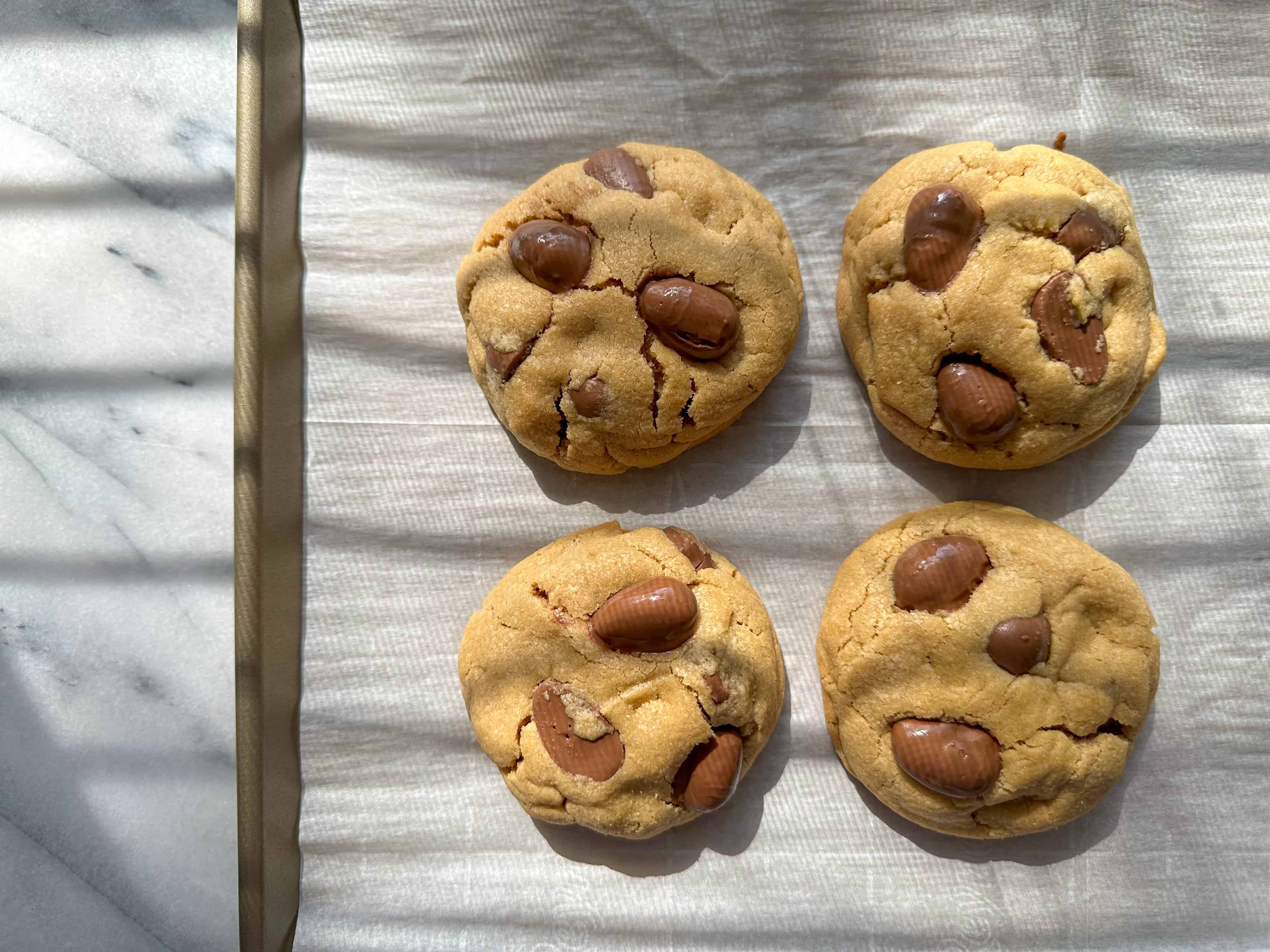 Reese's Egg Peanut Butter Cookies on a gold sheet tray.
