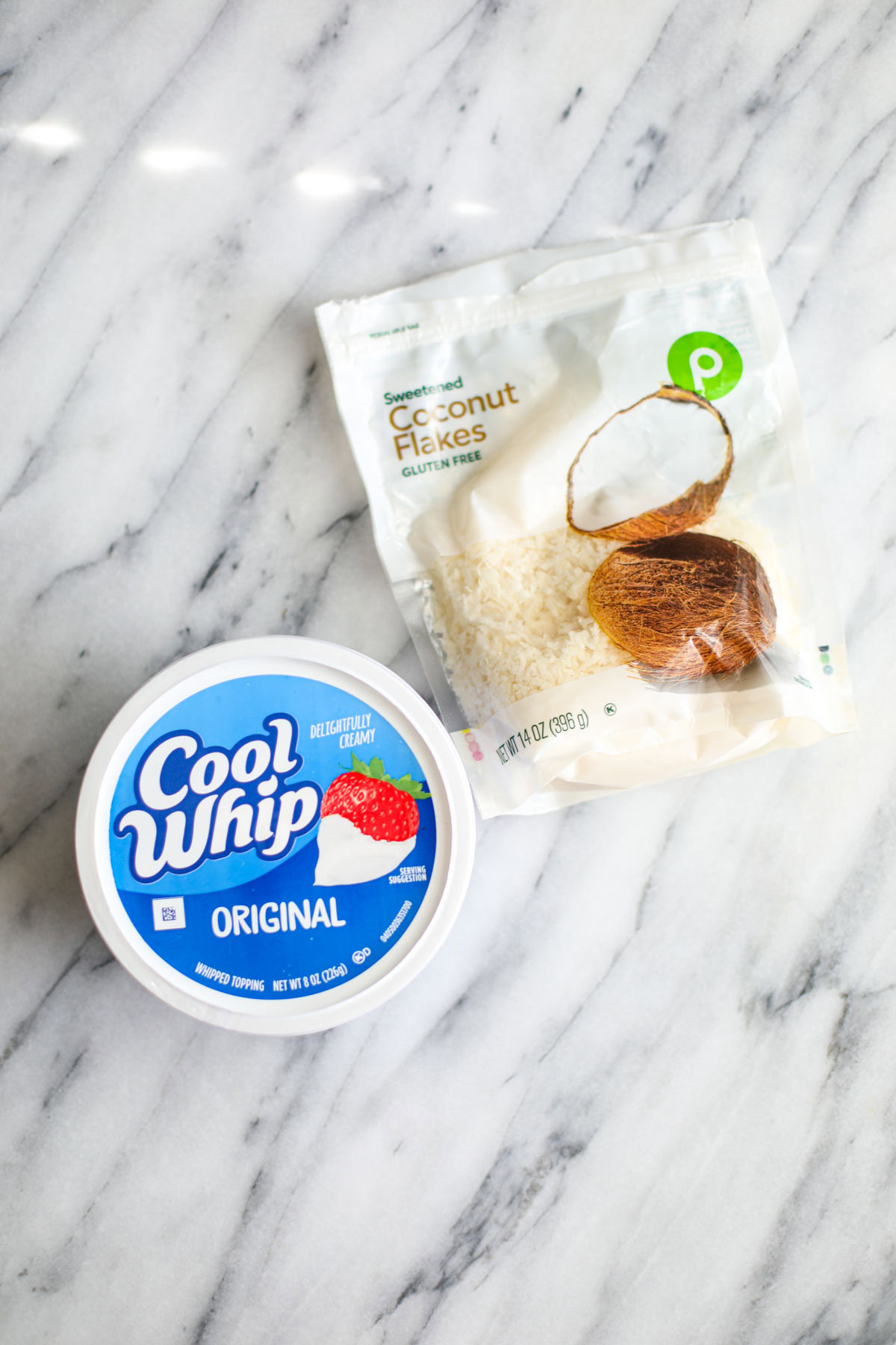 A bag of coconut flakes and a container of cool whip.