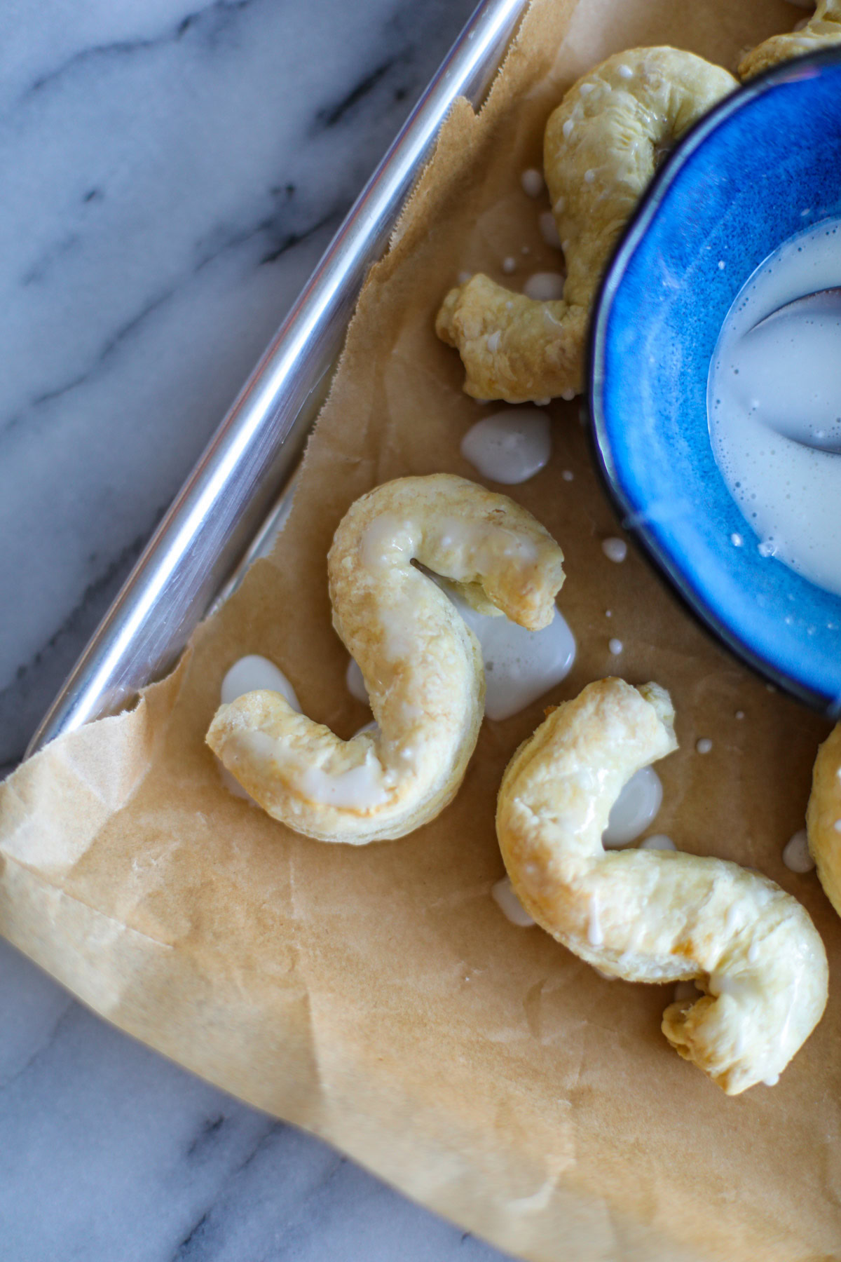 Two puff pastry Almond S Cookies on parchment paper. 