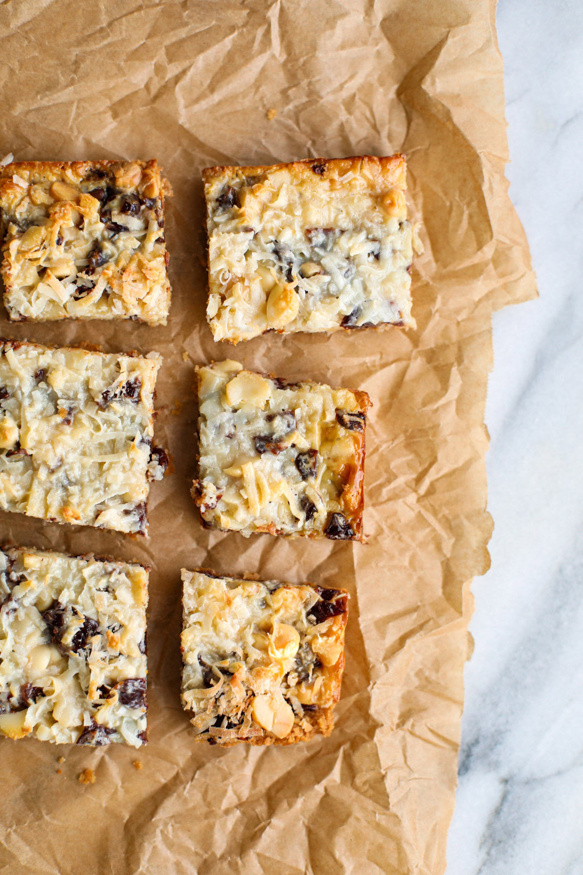 Two rows of magic bars on crinkled brown parchment paper.