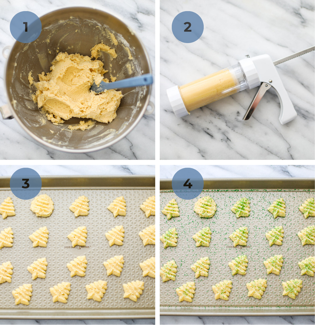 A bowl of christmas spritz cookie dough, a cookie press filled with dough, and baking sheets with pressed christmas trees with green sprinkles.