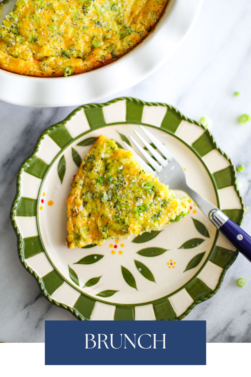 A slice of broccoli cheese quiche on a green and white plate with a blue fork. 