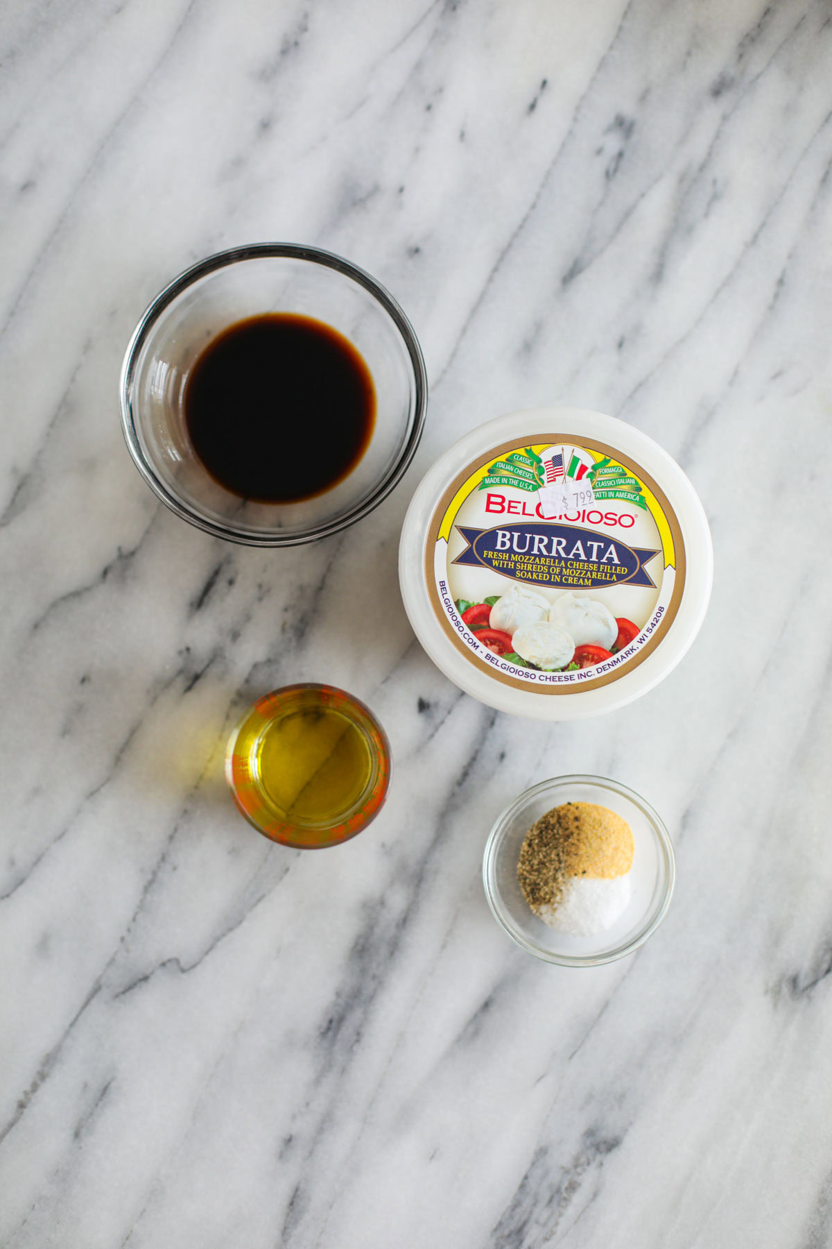 Marinade ingredients for balsamic grilled vegetables with burrata on a white counter top.