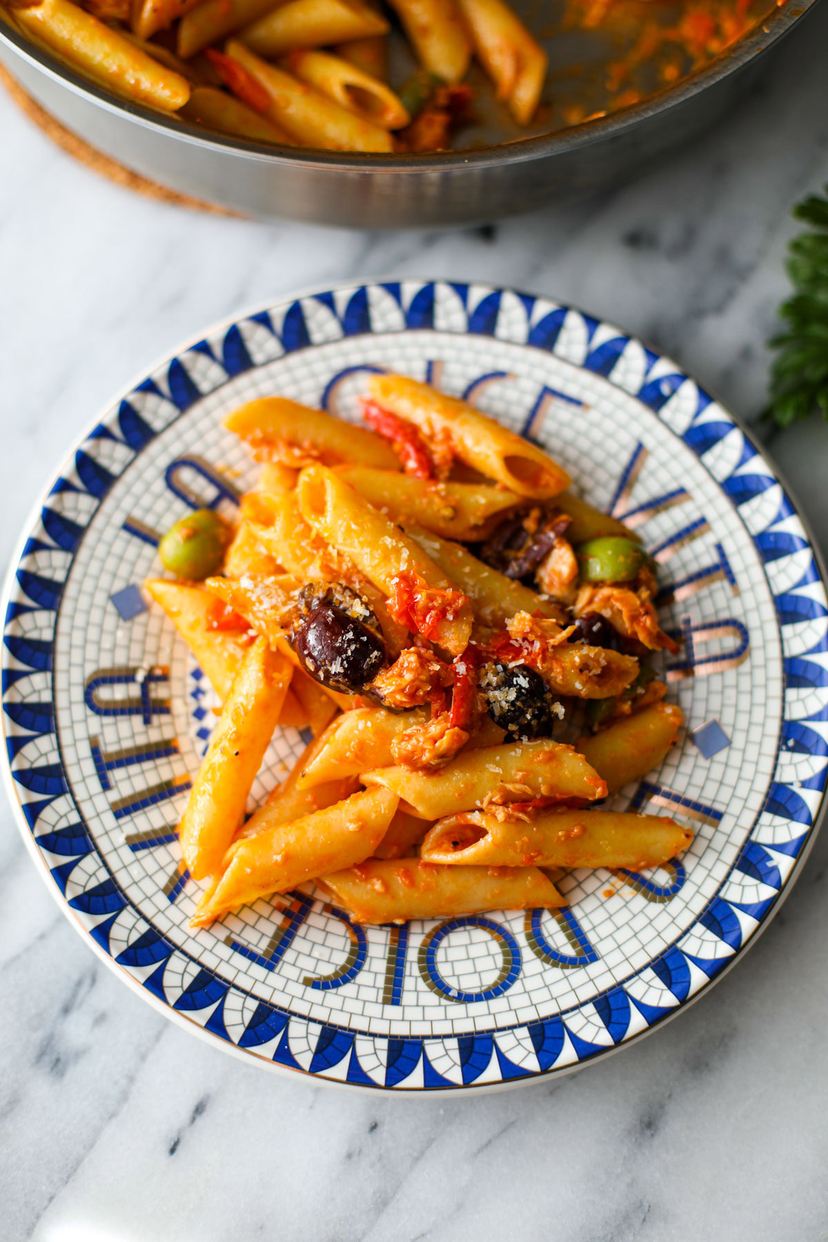 A serving of pasta on a blue and white plate.