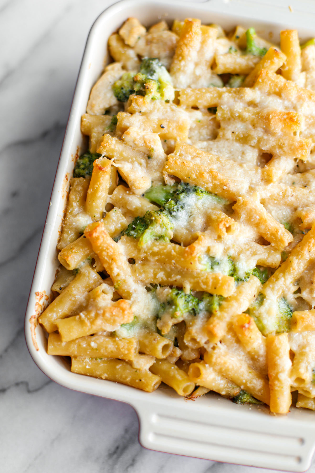 A square baking dish of chicken broccoli ziti.