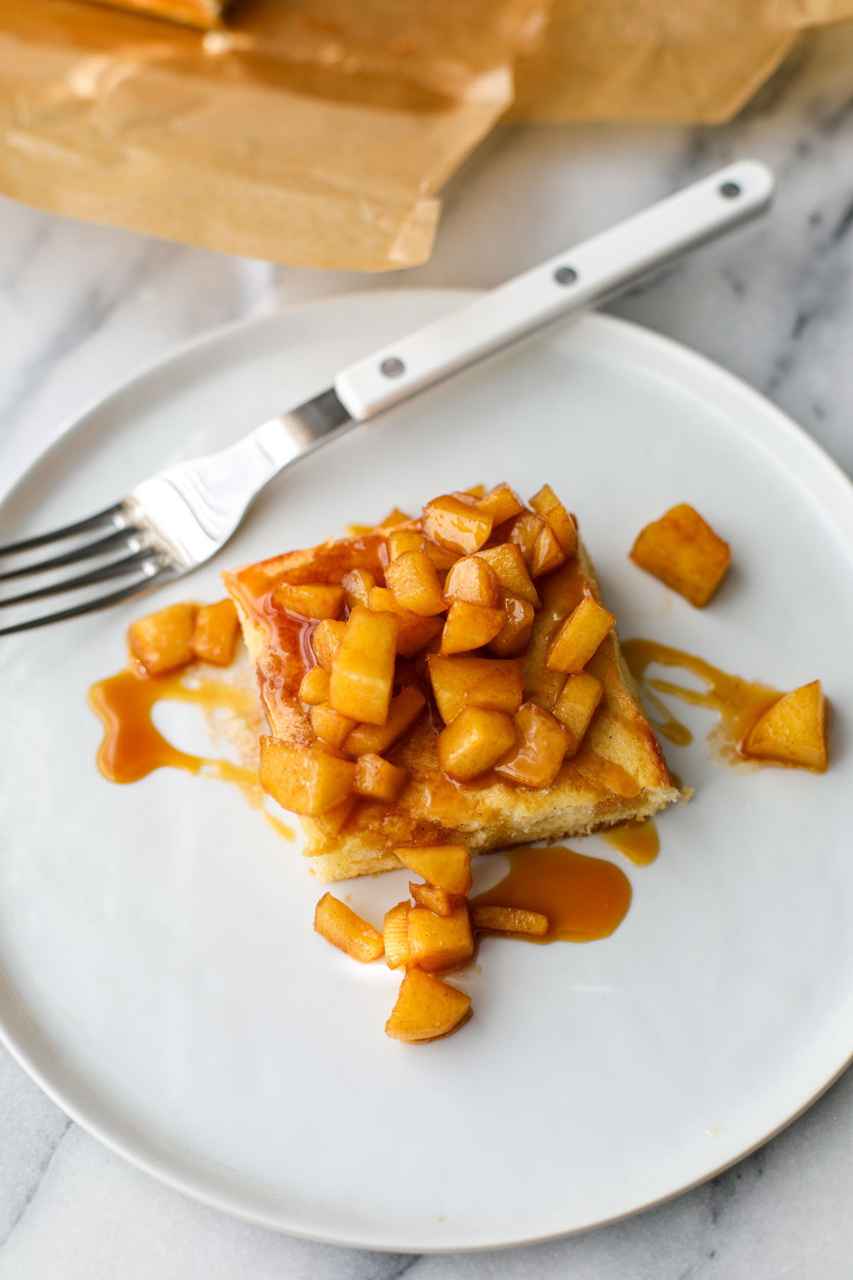 Caramel Apple Butter Cake on a white plate with a white fork.