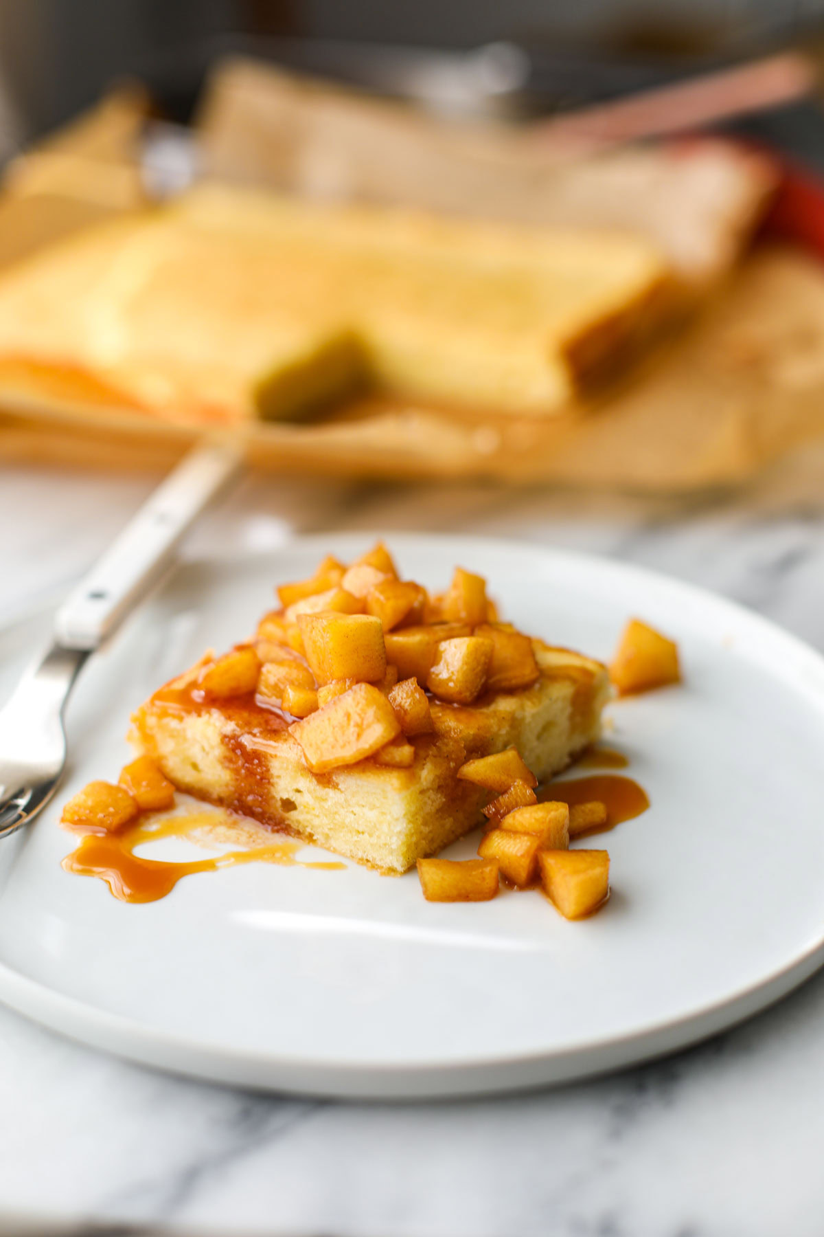 Caramel Apple Butter Cake on a white plate with a white fork.
