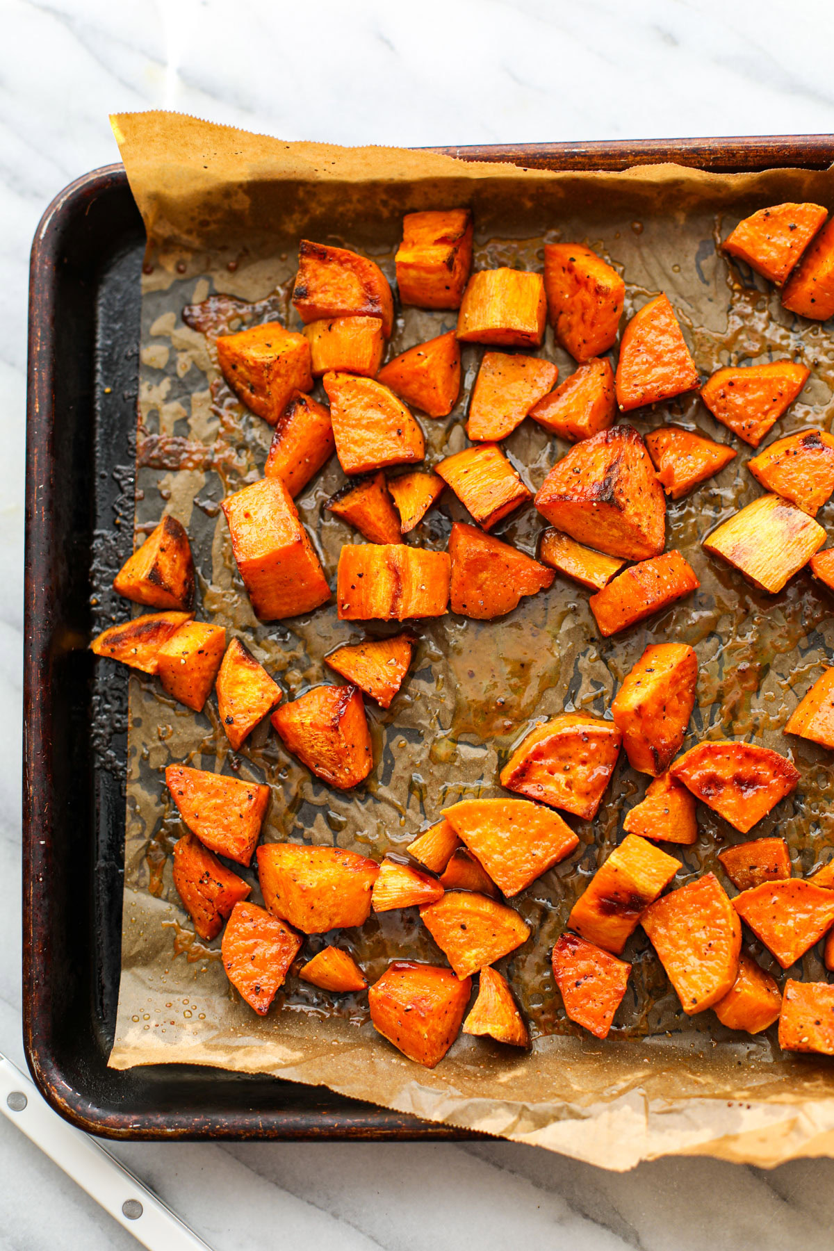 Maple Dijon Sweet Potatoes on a sheet tray.