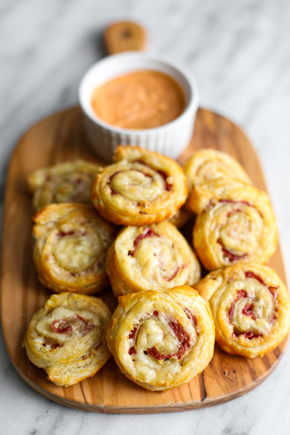 Rueben pinwheels on a cutting board.