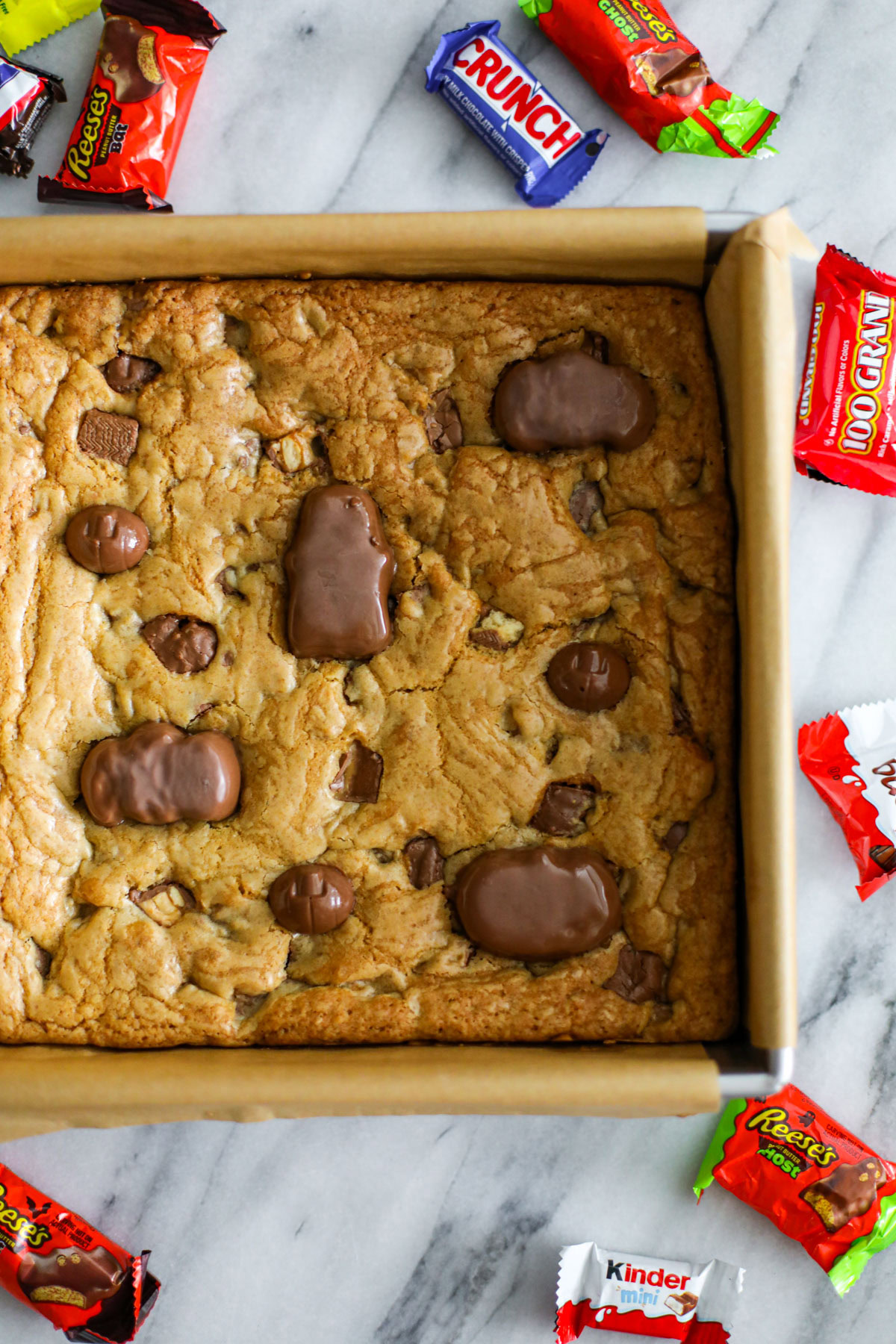 Pan of baked leftover Halloween candy cookie bars before slicing.
